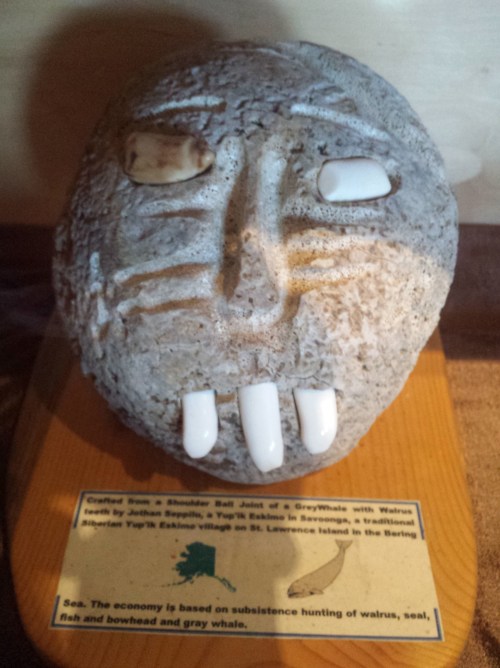 Whale humeral epiphysis (joint) turned into a sculpture with walrus ivory teeth, at Point Vicente Museum, LA.